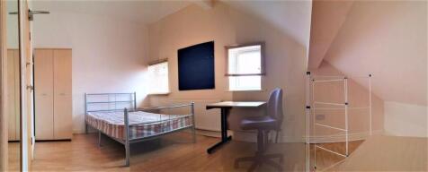 A spacious and bright master bedroom featuring ...