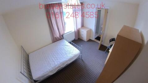 A cozy single bedroom featuring a comfortable b...