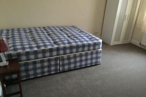 A tidy double bedroom featuring a comfortable b...