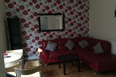 A cozy living room featuring a stylish red L-sh...