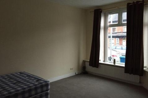 A simple, clean single bedroom with a large win...