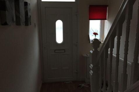 A neat and simple hallway featuring white walls...