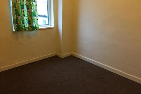 A small room with plain walls, a single window ...