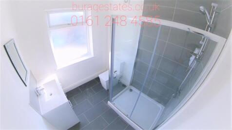 Bright and modern bathroom suite featuring a sp...