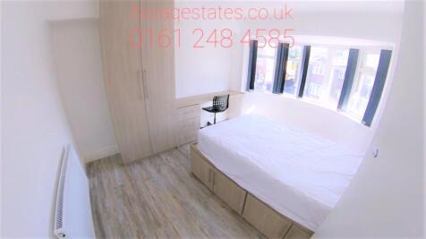 A bright and tidy double bedroom featuring a co...