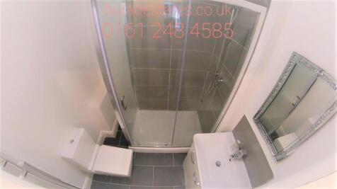 Bright and modern bathroom featuring a spacious...