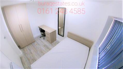 A bright, clean single bedroom featuring a comf...