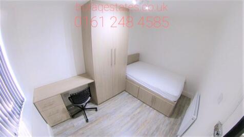 A neat and functional single bedroom featuring ...