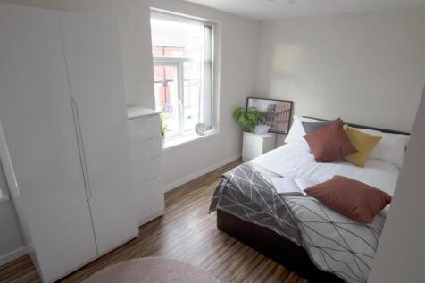 Bright and cozy double bedroom featuring a comf...