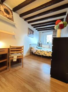 Cozy single bedroom featuring attractive expose...