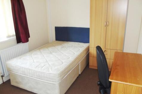 A simple and tidy single bedroom featuring a co...