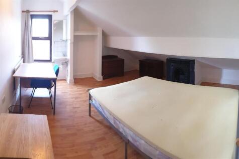 Bright and airy master bedroom featuring a larg...