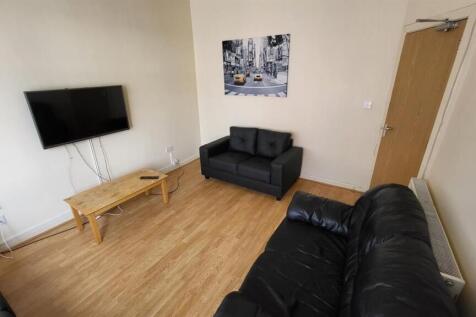 A cozy living room featuring two black leather ...