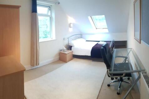 Bright and spacious master bedroom featuring a ...