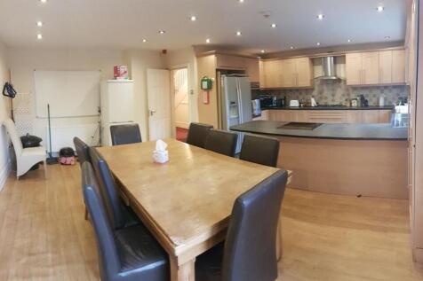 A modern kitchen and dining area featuring a la...