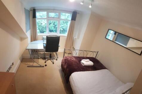 Bright and cozy bedroom featuring a comfortable...