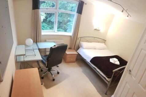 Bright and inviting bedroom featuring a large w...