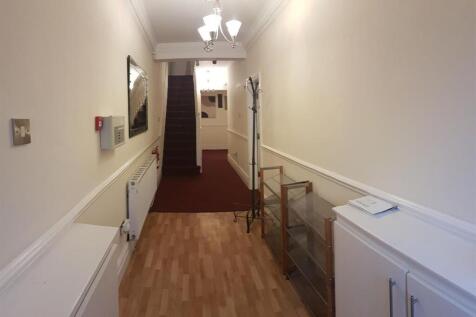 A clean and well-maintained hallway with light ...