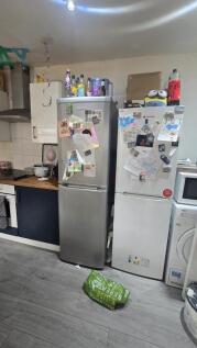 A functional kitchen area featuring two refrige...