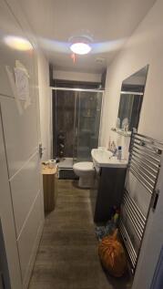A modern bathroom featuring a walk-in shower wi...