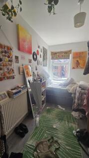 Cozy single bedroom featuring a bright window w...