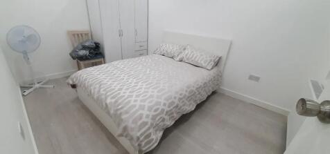 This cozy double bedroom features a comfortable...