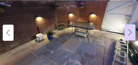 A charming outdoor space featuring a well-paved...
