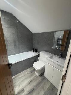 A modern, clean bathroom featuring a sleek whit...