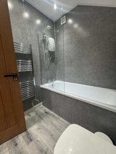 A modern bathroom suite featuring a clean white...