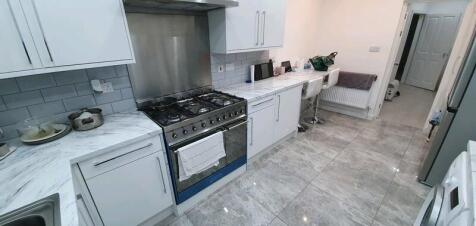 A modern, bright kitchen featuring marble count...