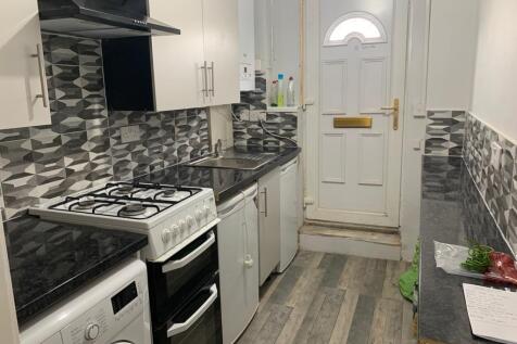 A neat and functional kitchen featuring modern ...