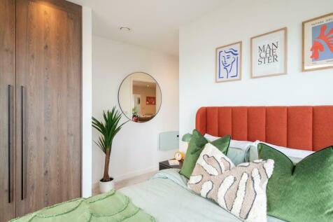 A stylish master bedroom featuring a vibrant or...