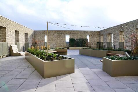 A modern rooftop garden area featuring sleek, r...