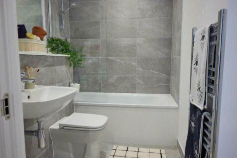 A modern and tidy bathroom featuring a stylish ...