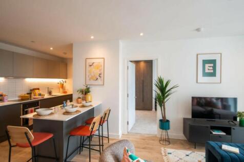A spacious and modern living room with a well-m...