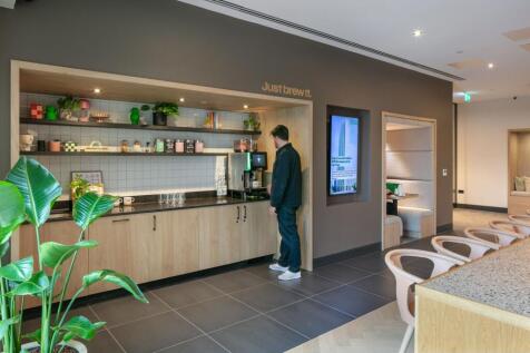 A modern communal lounge area featuring a sleek...