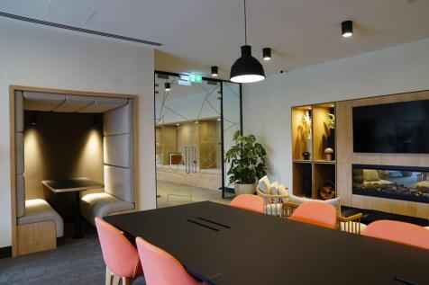 Modern communal workspace featuring a large bla...