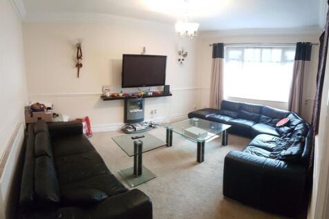 A spacious living room featuring multiple black...