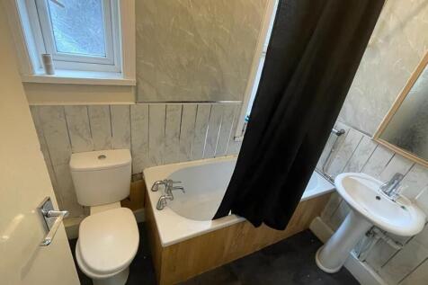 A clean and functional bathroom suite featuring...