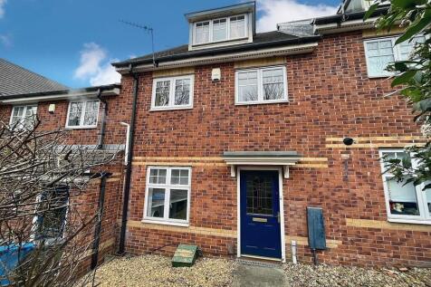 A well-maintained brick terraced house front fe...