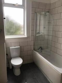 Bright and clean bathroom featuring a modern ba...