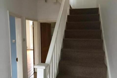 A clean and well-maintained hallway with white ...