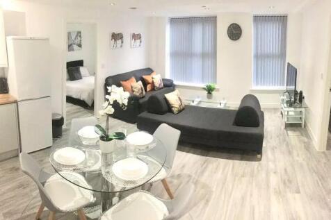 Bright and modern open-plan living room with co...
