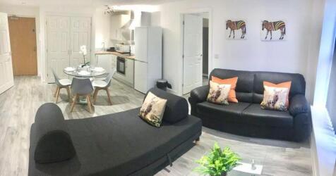 Bright and modern living room featuring comfort...
