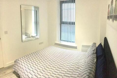 A cozy double bedroom featuring a neatly made b...