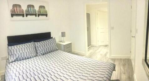 A neat and modern double bedroom featuring a co...