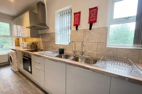 Bright and modern kitchen featuring sleek cabin...