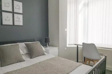Bright and stylish master bedroom featuring a c...