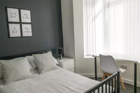 A stylish double bedroom featuring a comfortabl...