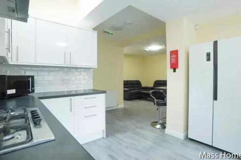 Bright and modern kitchen featuring sleek white...